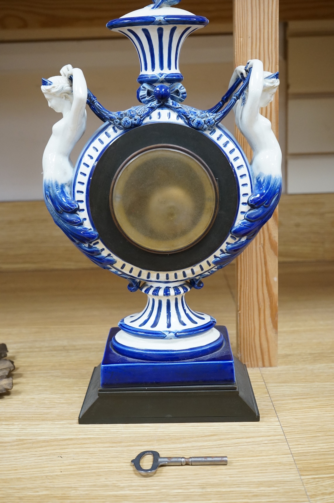 An early 20th century figural glazed ceramic mantle clock, 21cm wide x 40cm high